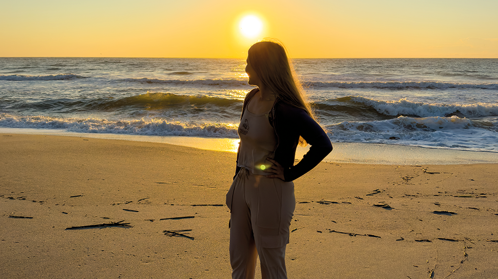 Alina enjoys the unforgettable sunset on the beach.